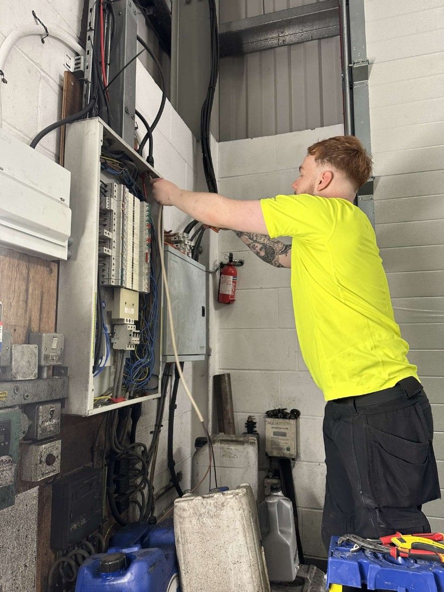 Luke from 2Morrows Electrical working on a three-phase distribution board